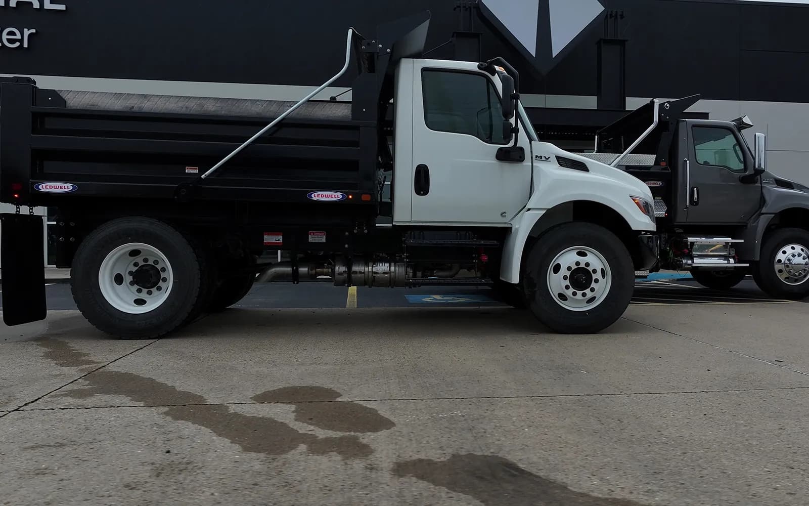 White International MV dump truck with a Ledwell 5 to 6 yard steel dump body, side view