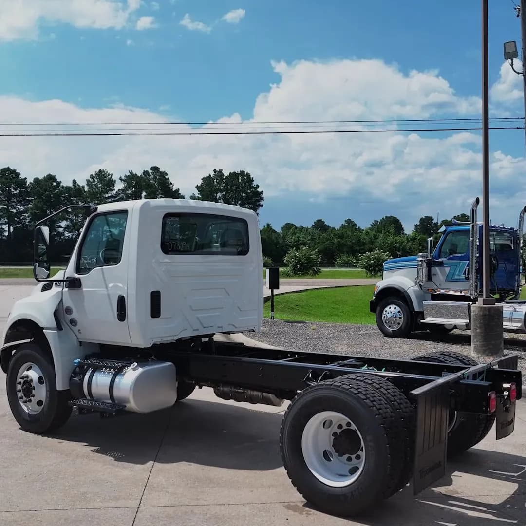 White International MV cab and chassis with no body fitted, on a dealer lot