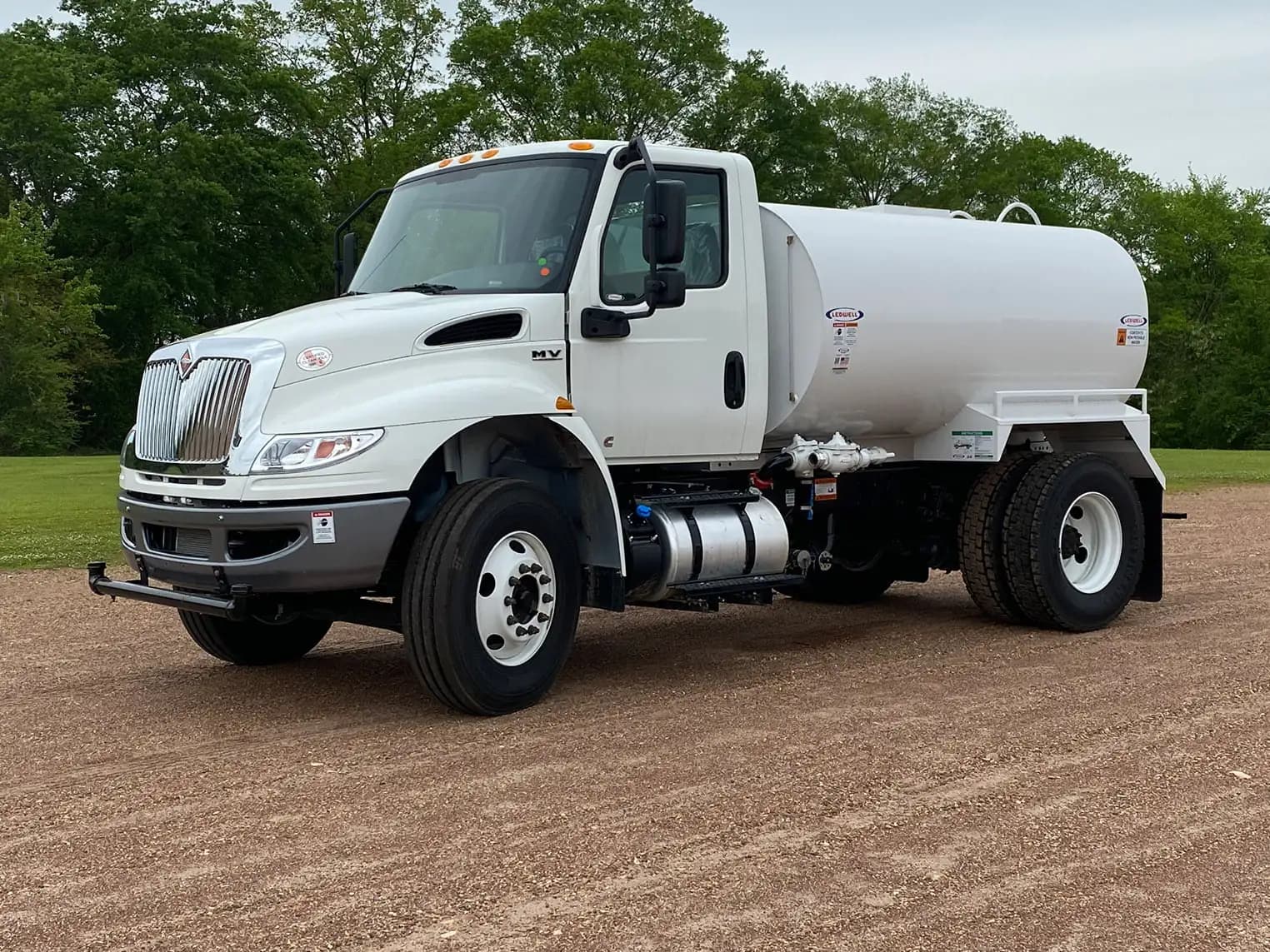 Ledwell 2,000-gallon water truck on an International MV chassis, front three-quarter view