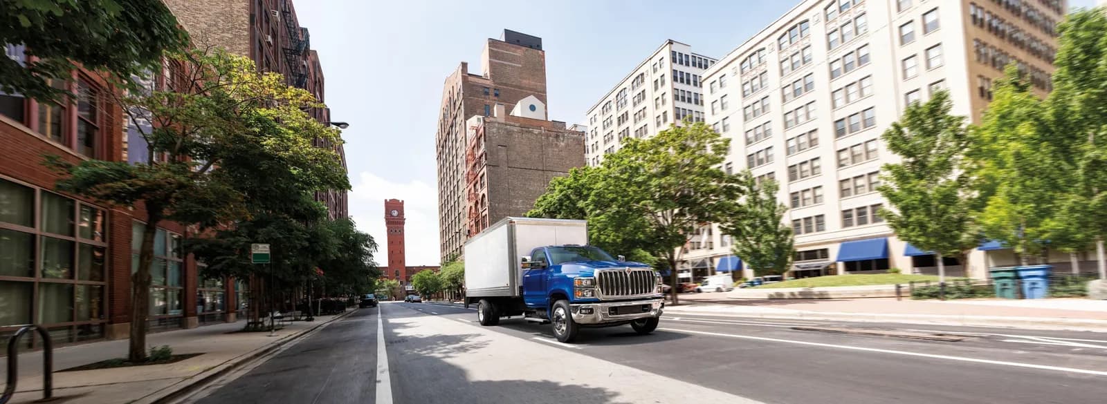 Blue International CV Series box truck on an urban delivery route