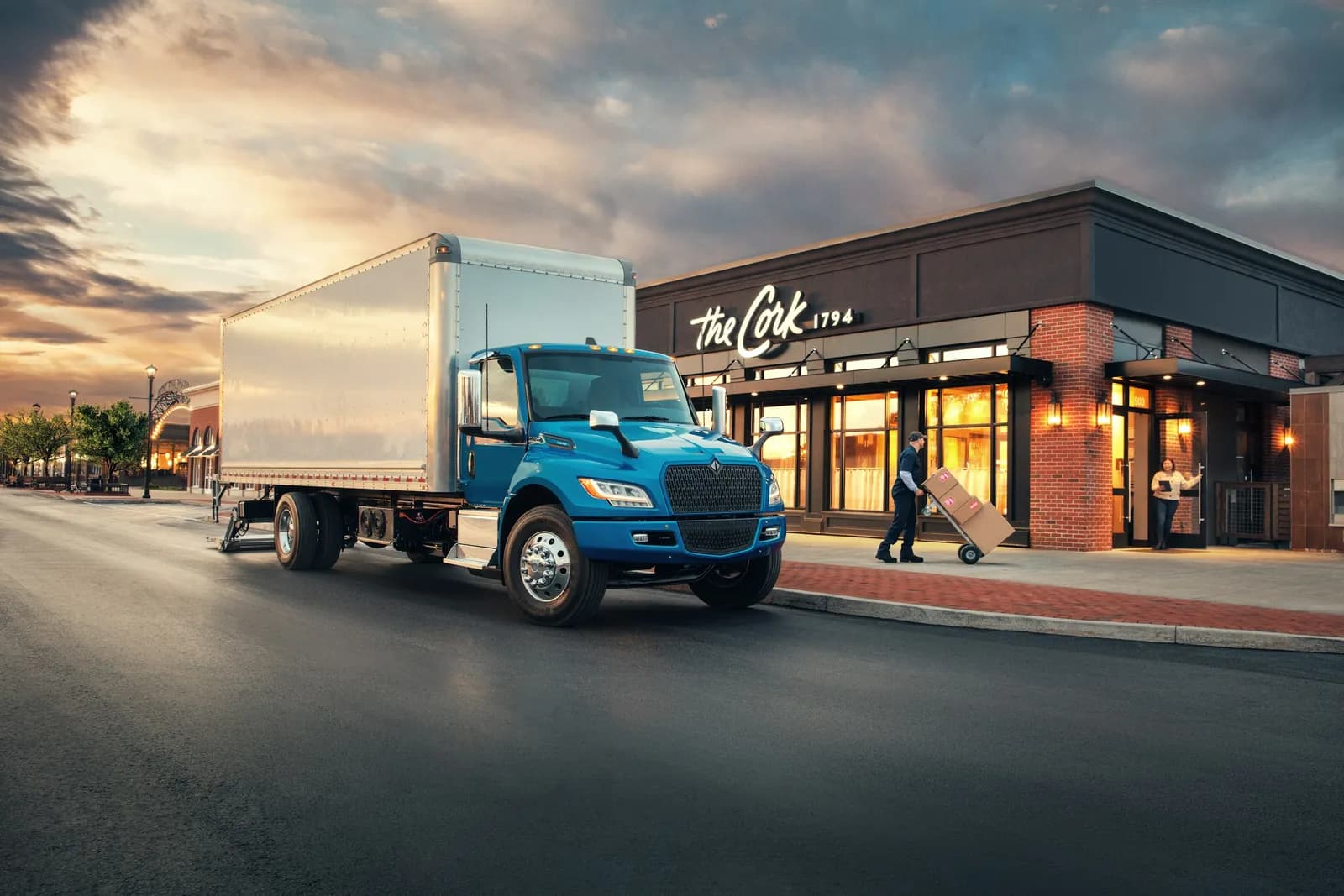 Blue International eMV Series box truck on a quiet city delivery route
