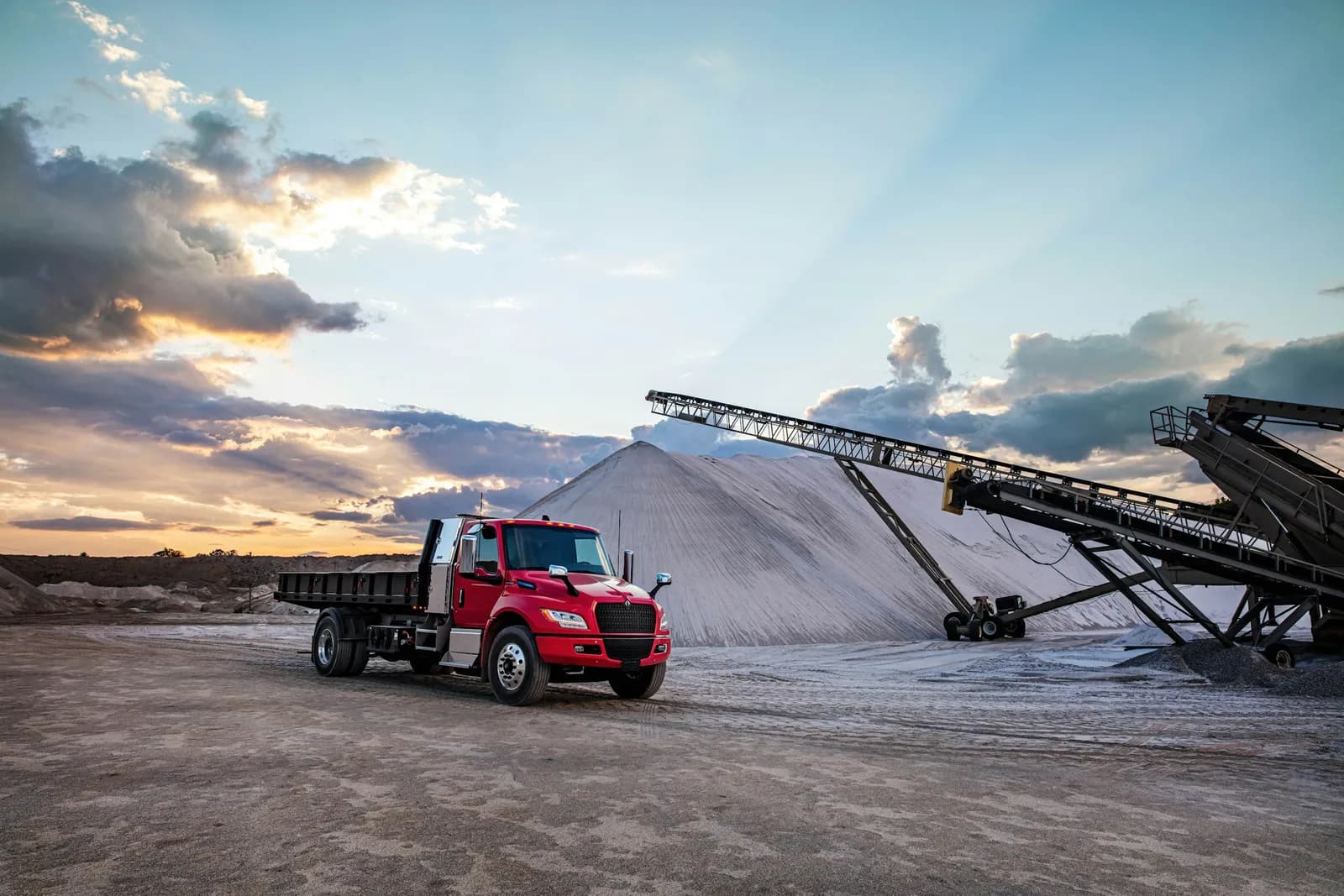 International eMV Series dump truck working in a dirt field