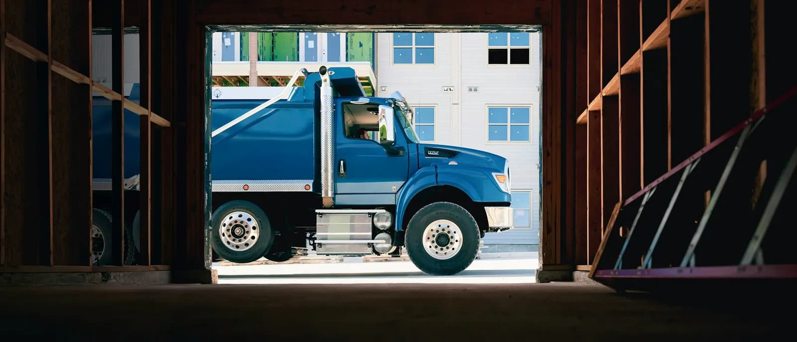 International HV Series dump truck side shot at a construction site