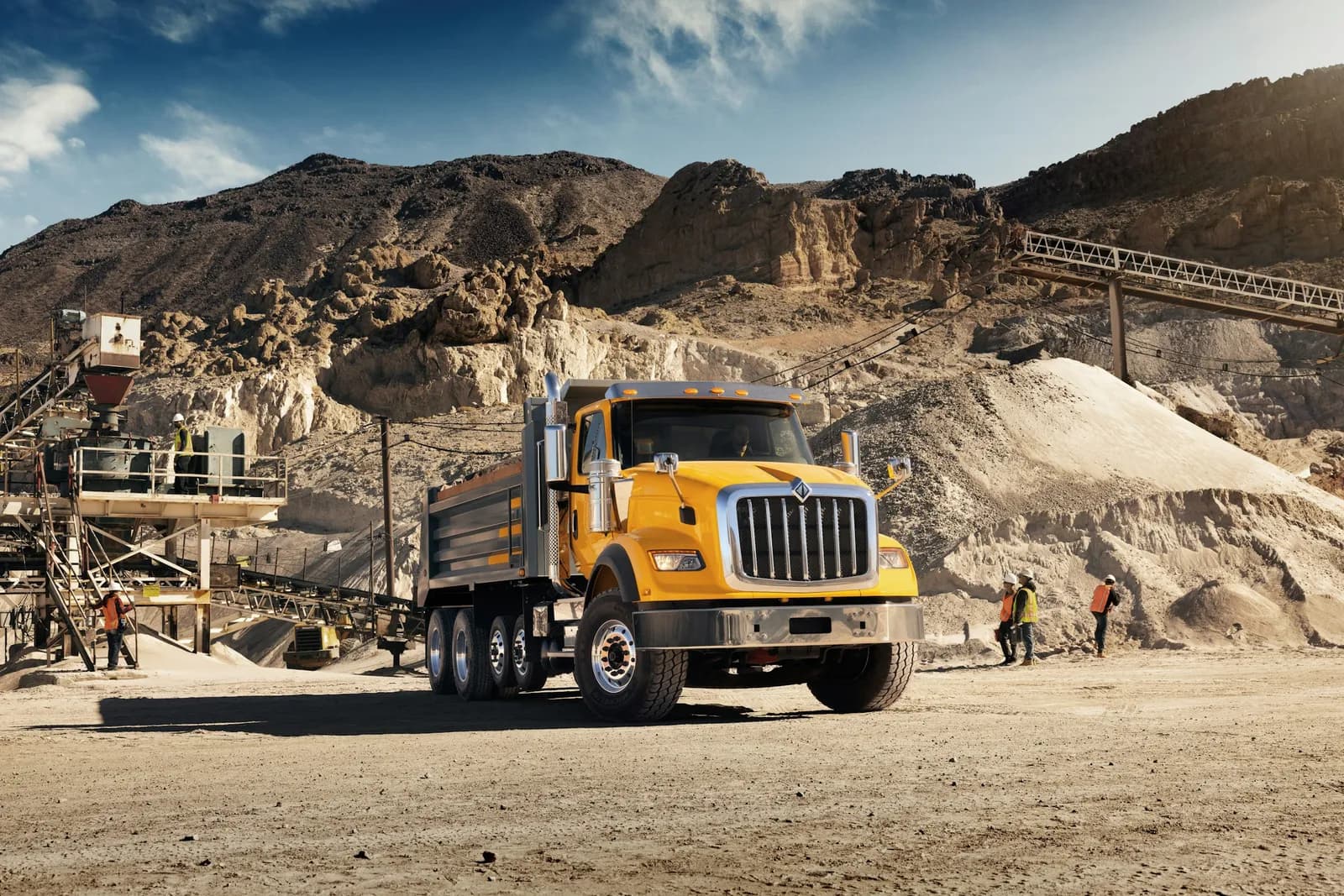 Yellow International HX Series construction dump truck on a dirt road