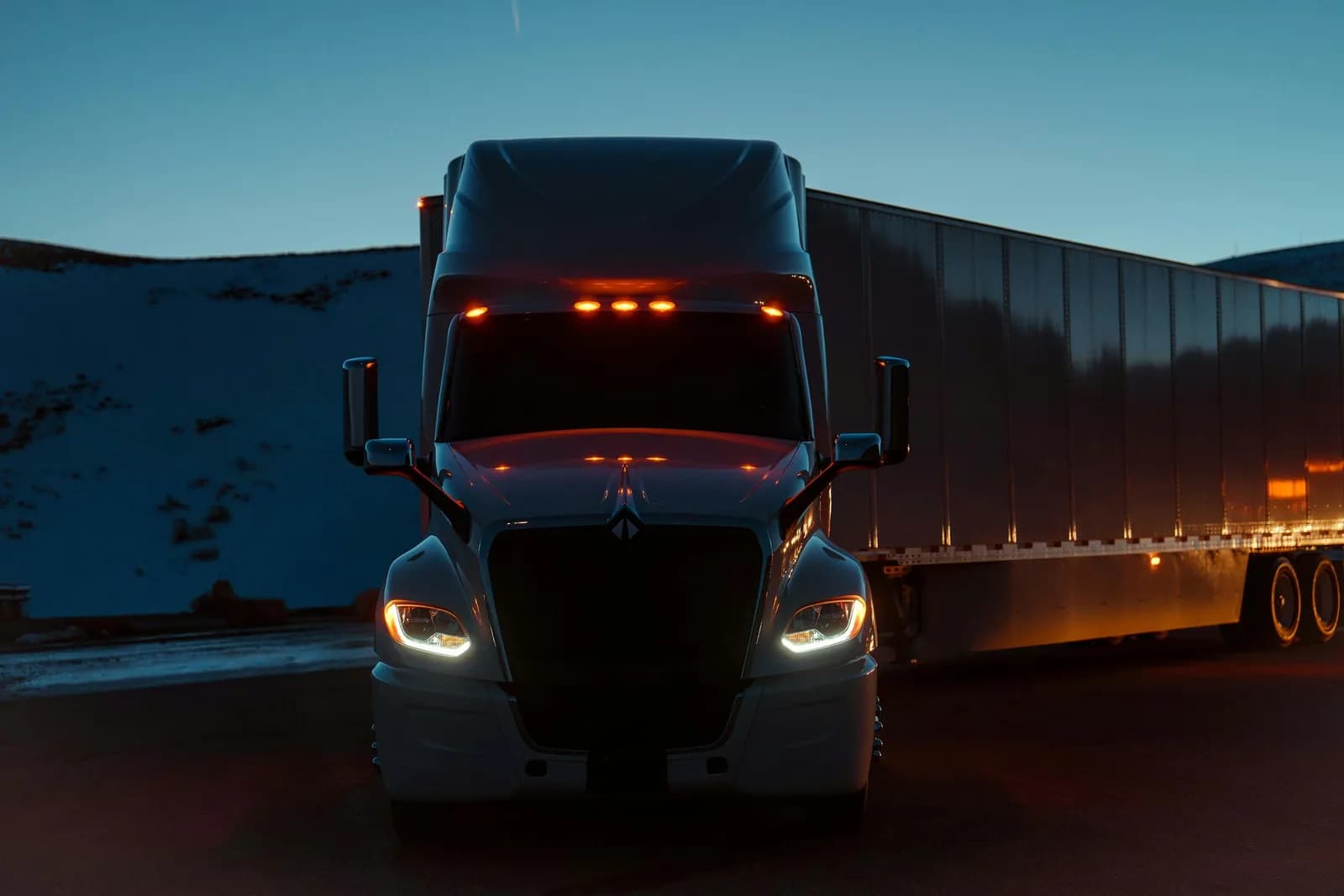 International LT Series parked at night beneath snowy mountains