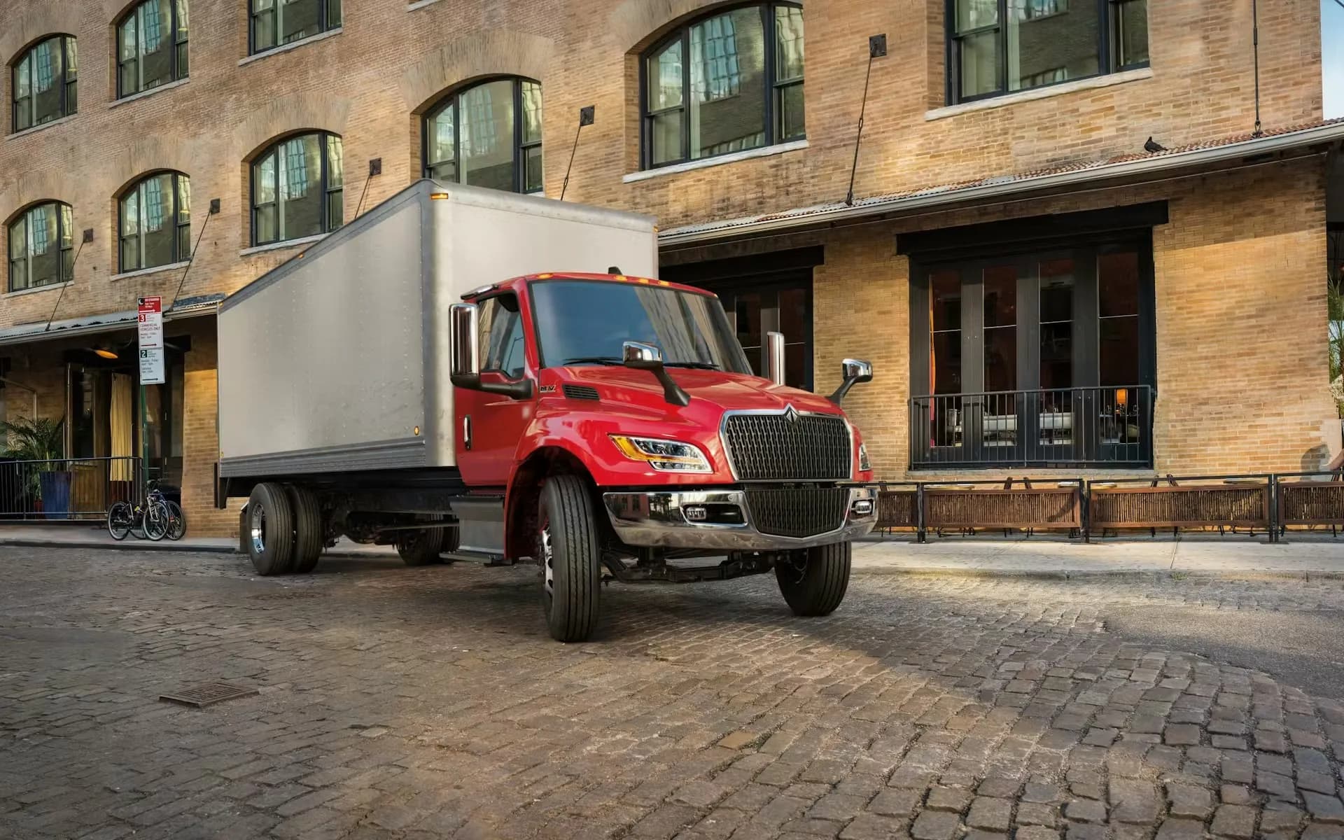 Red MV Series box truck on a delivery route