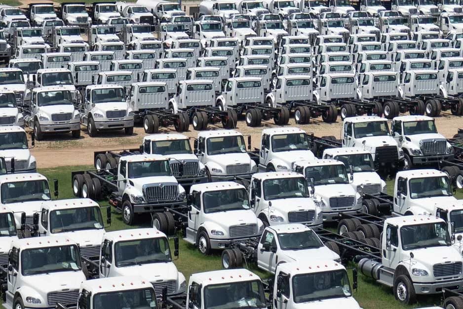 Rows of cab-and-chassis units parked in the Ledwell truck yard
