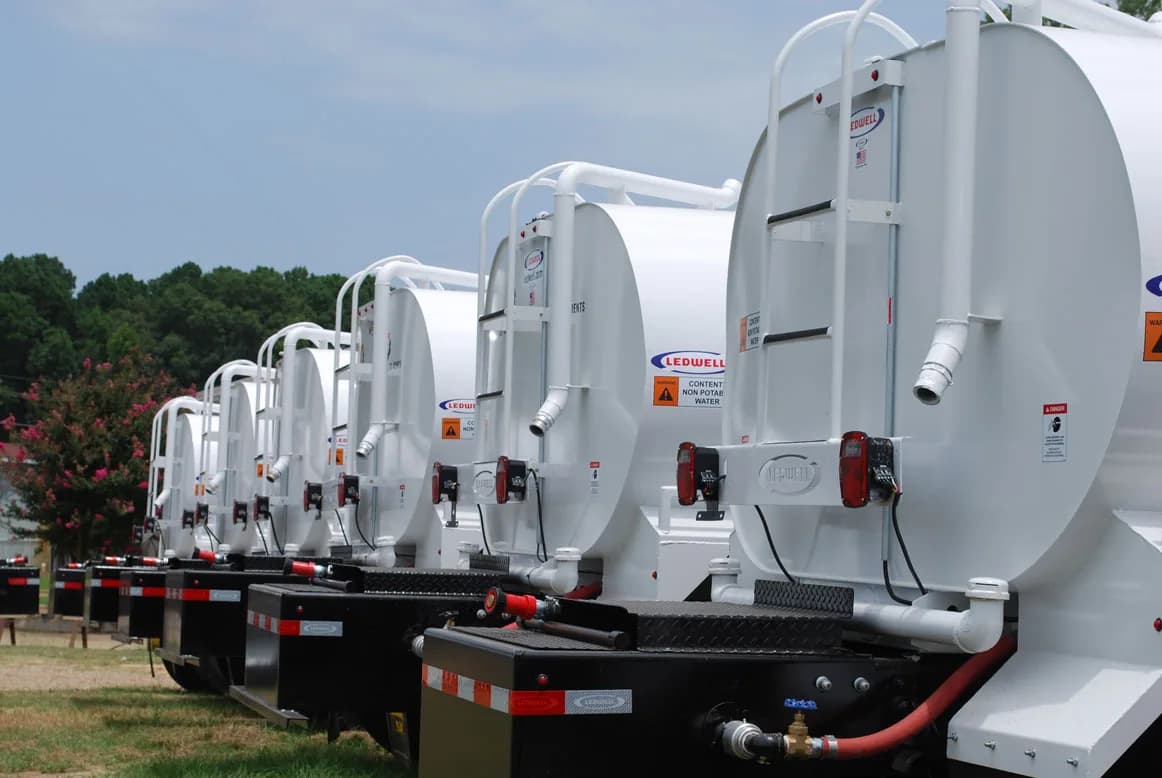Row of Ledwell water tank bodies lined up, rear view