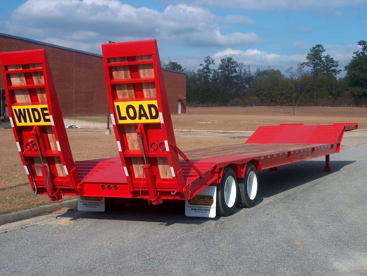 Red McLendon lowboy with wide-load ramps raised