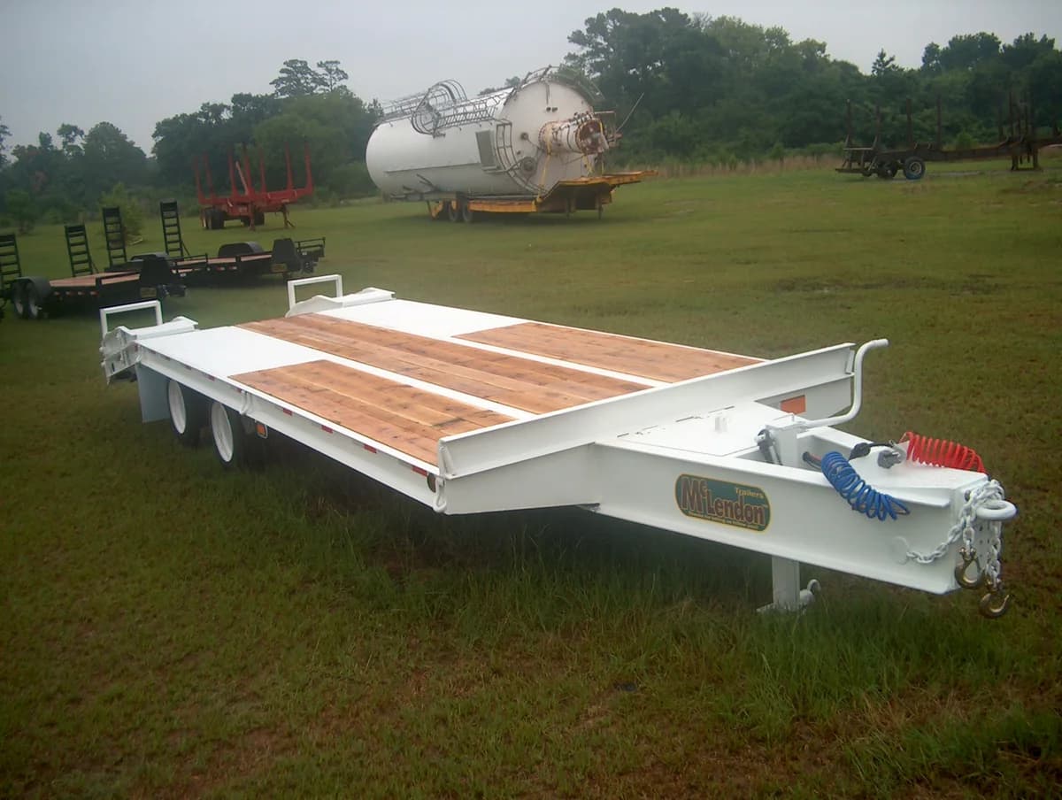 White McLendon specialty tank hauler trailer parked in a field