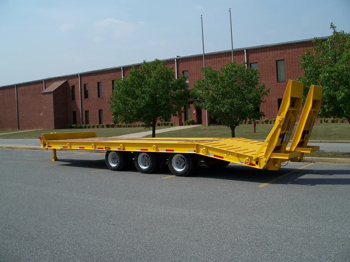 Yellow McLendon tag trailer with ramps lowered