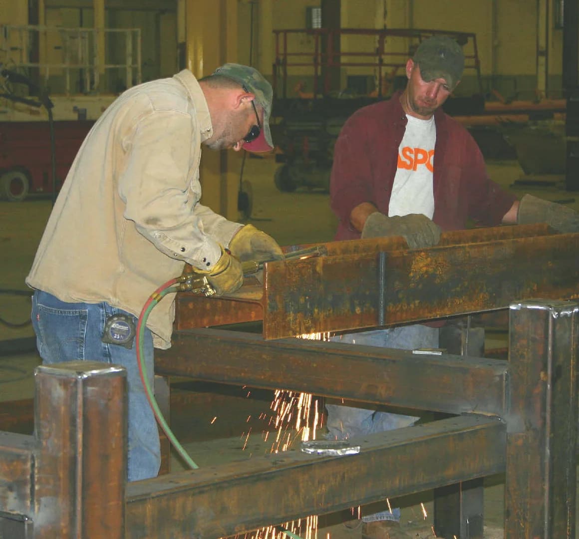 Fabricators welding a McLendon trailer frame in the Phenix City shop