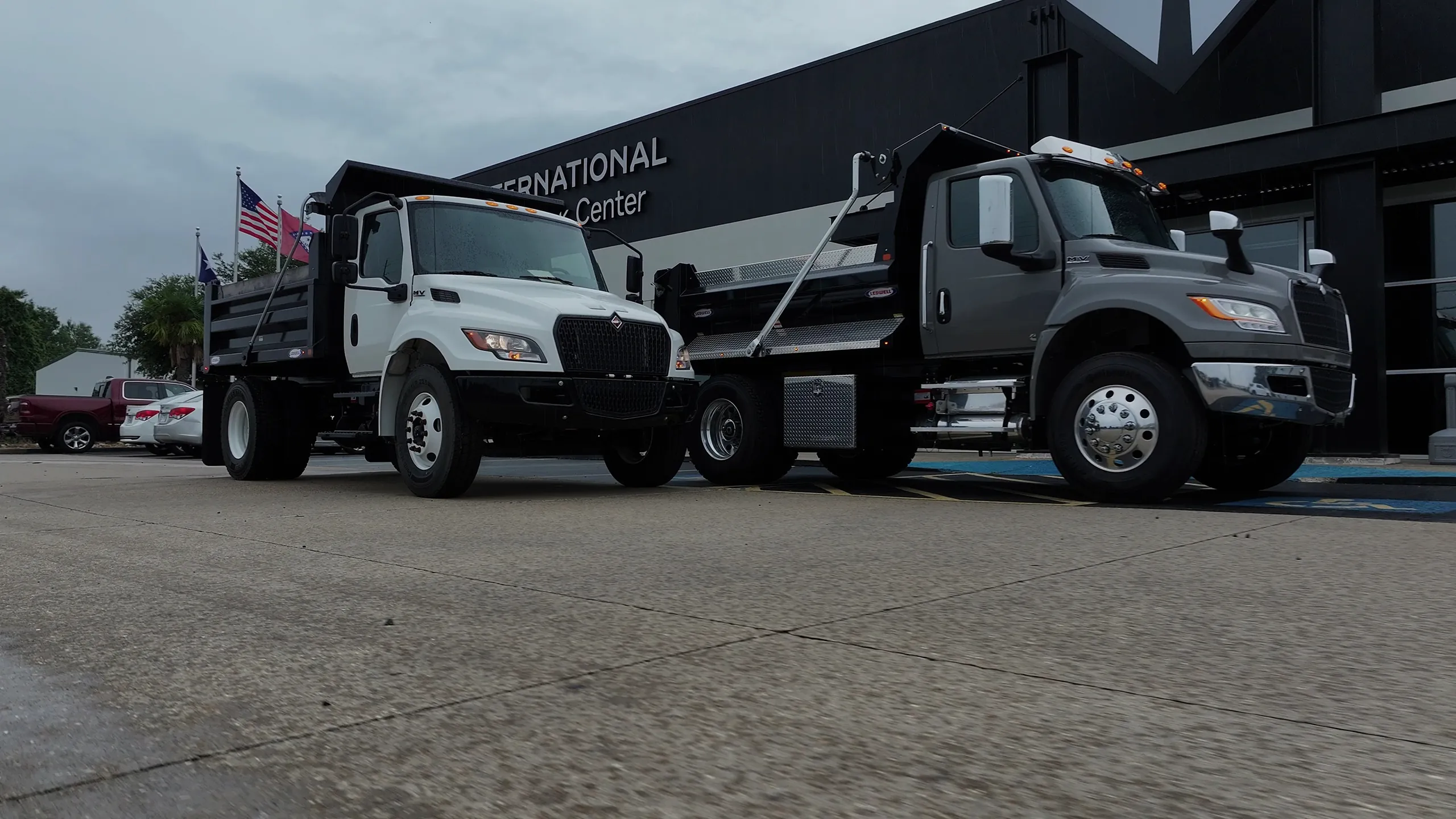 International dump trucks with Ledwell bodies parked in front of the Artex Truck Center building in Texarkana