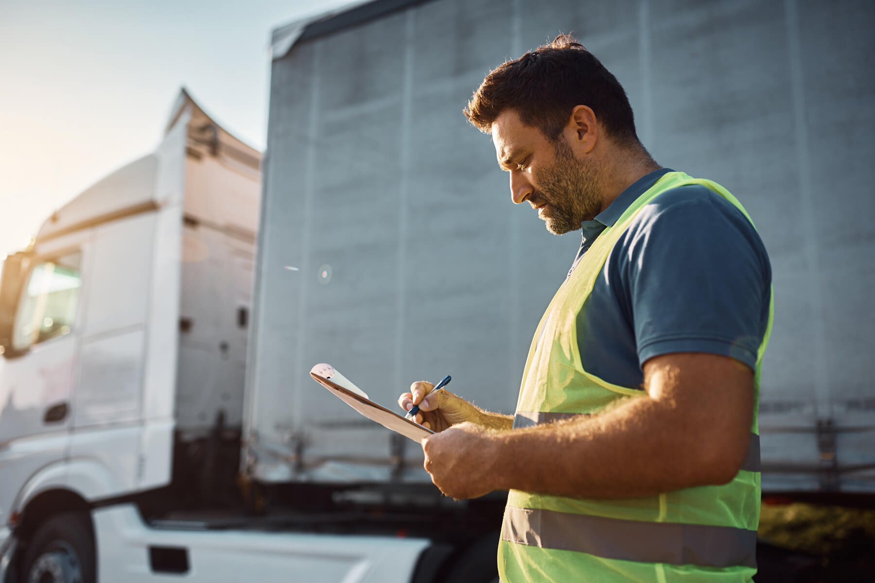 Driver review paperwork outside of truck